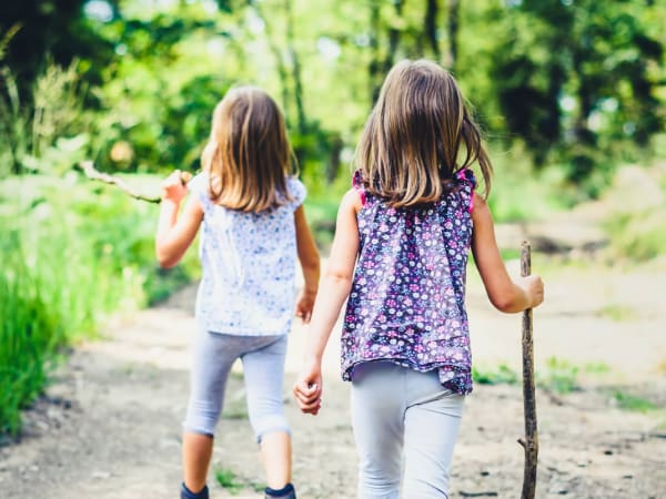 Two young girls on a hike in the woods